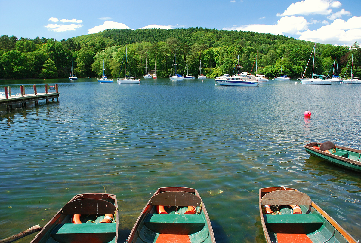 Lake Windermere with rowing boats in the foreground and sailing boats in the background