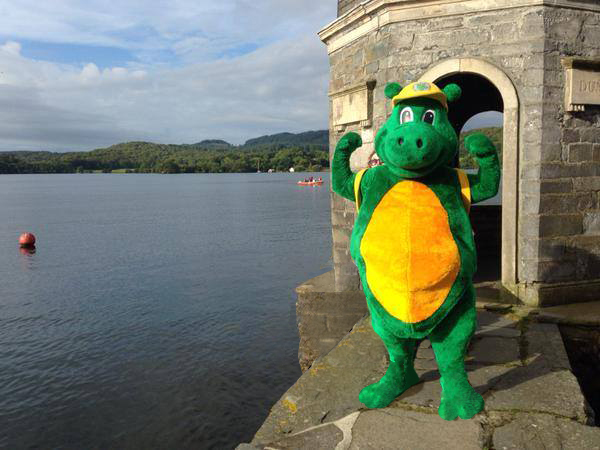 Bownessie standing on a pier by Lake Windermere